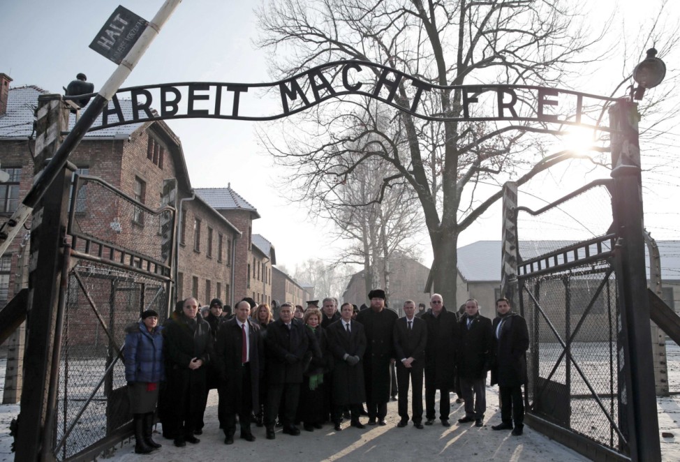 Israelian Minister of Immigrant Absorption Landver, the newly elected head of Israel's left-of-centre Labour Party Herzog and the director of Auschwitz Cywinski and members of the Knesset pose at the entrance of the former concentration camp in Auschwitz
