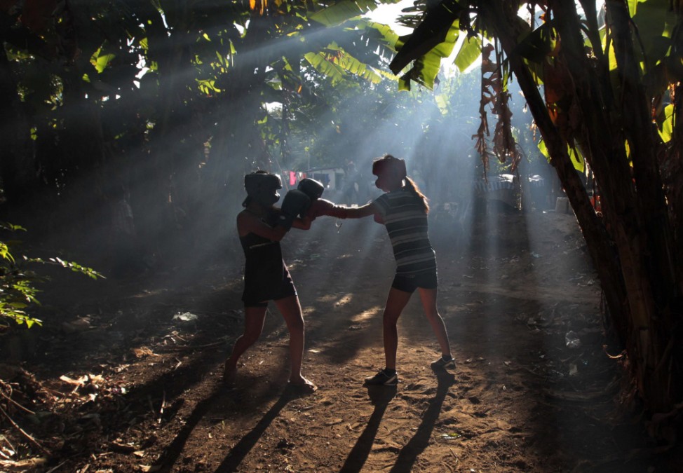 Aspiring boxers exchange punches during their training session at a boxing school in the indigenous community of Pacayita in Masaya