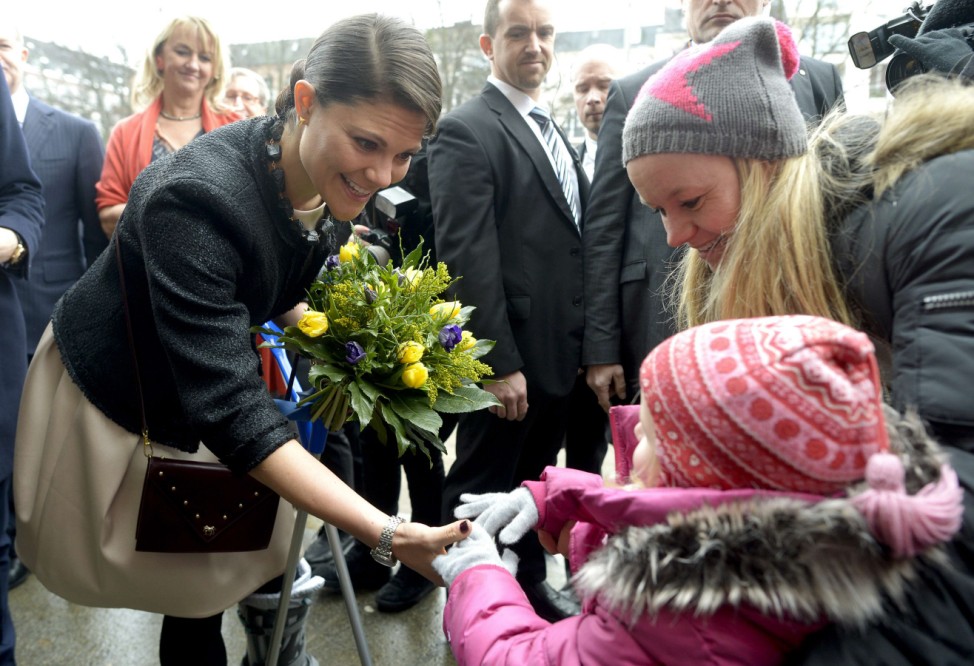 Sweden's Crown Princess Victoria receives flowers by 6-years-old Anouk as she and her husband Prince Daniel, the Duke of Vastergotland (not pictured), arrive at a museum in Hamburg