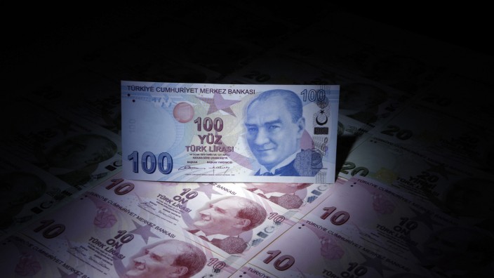 A Turkish 100 lira banknote is seen on top of 10 lira banknotes in this illustration picture taken in Istanbul
