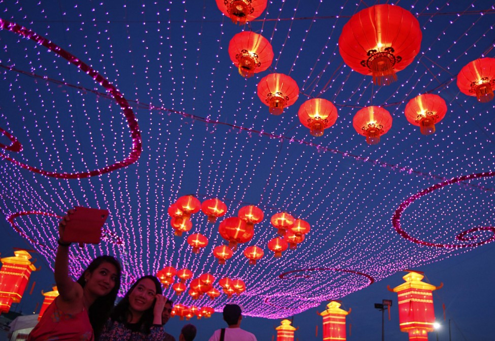 Revelers take photos of themselves during Chinese New Year celebrations ahead of the new year at Marina Bay in Singapore