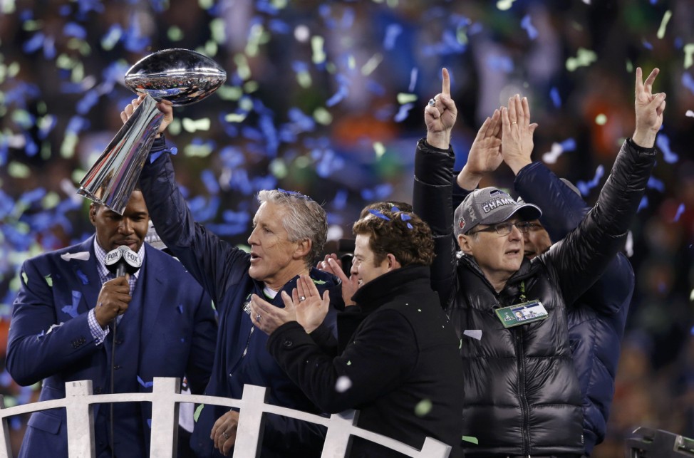 Seattle Seahawks head coach Carroll holds up the Vince Lombardi Trophy next to team owner Allen after they defeated the Denver Broncos in the NFL Super Bowl XLVIII football game in East Rutherford