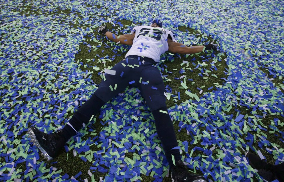 Seahawks' Smith makes an angel in the confetti after his team defeated the Denver Broncos in the NFL Super Bowl XLVIII football game in East Rutherford