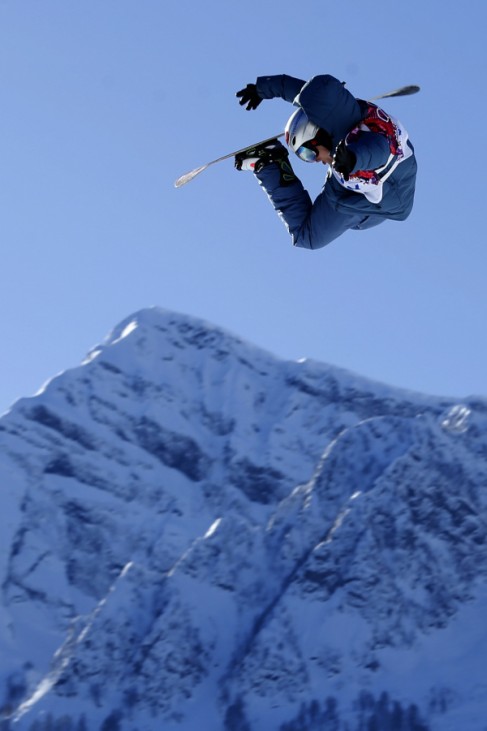 Japanese snowboarder Kadono takes air off a jump during slopestyle snowboard training at the 2014 Sochi Winter Olympics in Rosa Khutor