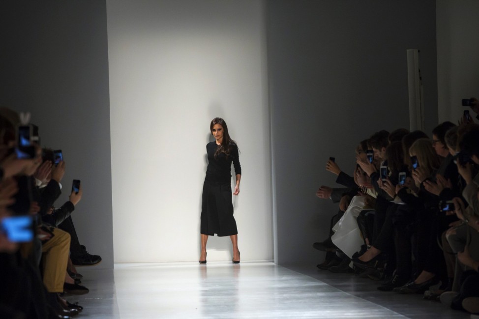 Designer Victoria Beckham greets the audience during her Fall 2014 collection at the New York Fashion Week