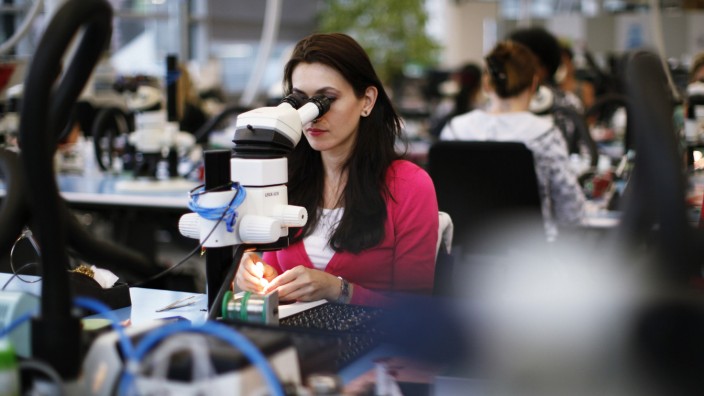 File photo of an employee working in production facility of Phonak hearing devices of Swiss hearing aid maker Sonova in Staefa