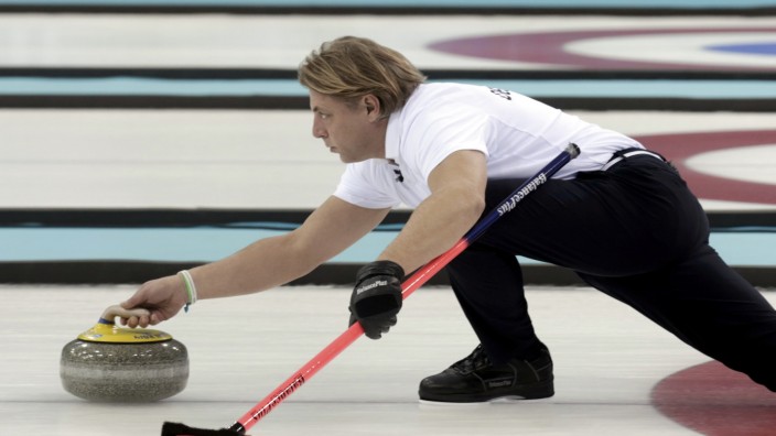 Germany's skip John Jahr delivers a stone during their men's curling round robin session game against Norway at the 2014 Sochi Olympics
