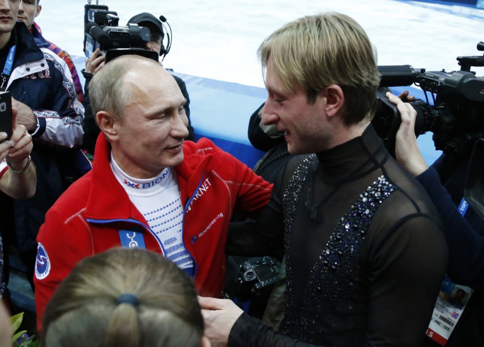 Russian President Putin greets Plushenko, a member of the gold medal-winning Russian figure skating team, during the 2014 Sochi Winter Olympics