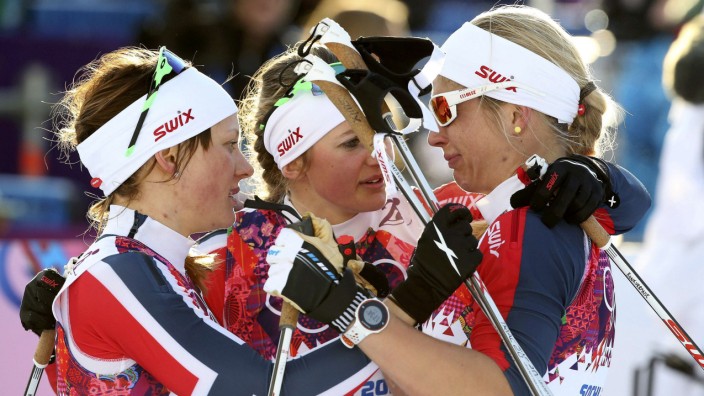 Winner Falla of Norway and her team mate, second placed Oestberg comfort Jacobsen after competing in the women's cross-country sprint free final at the Sochi 2014 Winter Olympic Games in Rosa Khutor