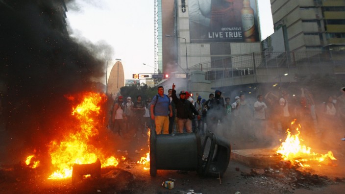 Demonstrators make a barricade of burning garbage during a protest against Venezuela's President Nicolas Maduro's government in Caracas