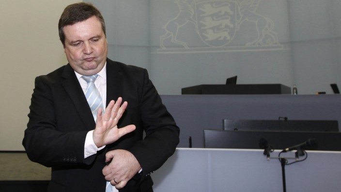 Former Baden-Wuerttemberg premier Mappus (CDU) gestures before hearing at EnBW commission of enquiry in Stuttgart