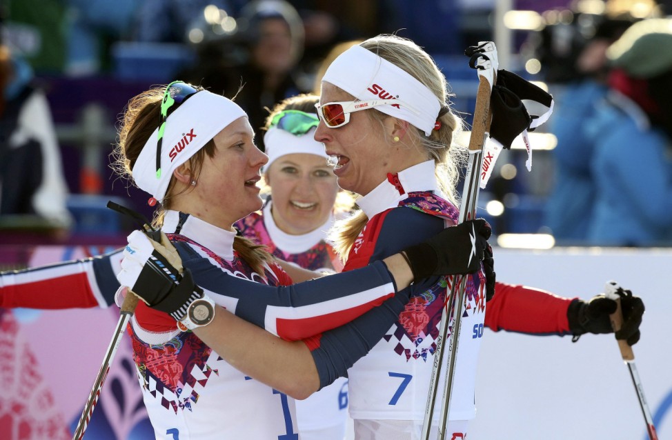 Winner Falla of Norway celebrates with her team mates, second placed Oestberg and Jacobsen after competing in the women's cross-country sprint free final at the Sochi 2014 Winter Olympic Games in Rosa Khutor