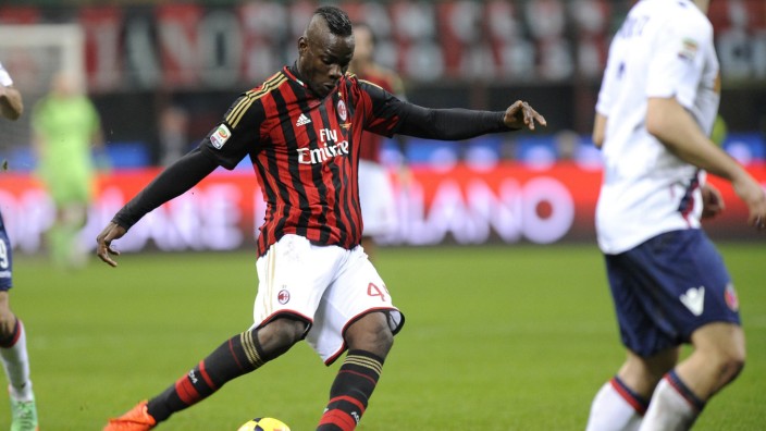 AC Milan's Mario Balotelli shoots to score against Bologna during their Italian Serie A soccer match in Milan