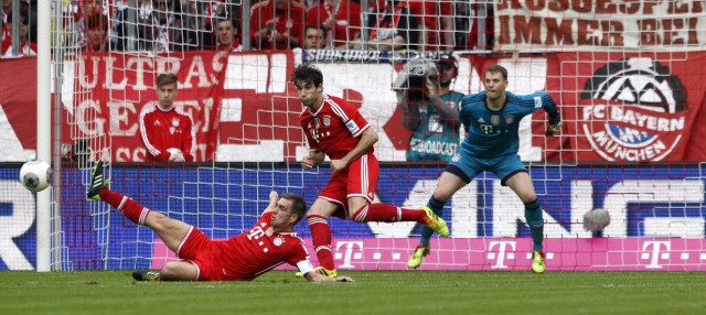 Bayern Munich's Lahm, Martinez and Neuer save a ball during their German Bundesliga first division soccer match against Freiburg in Munich