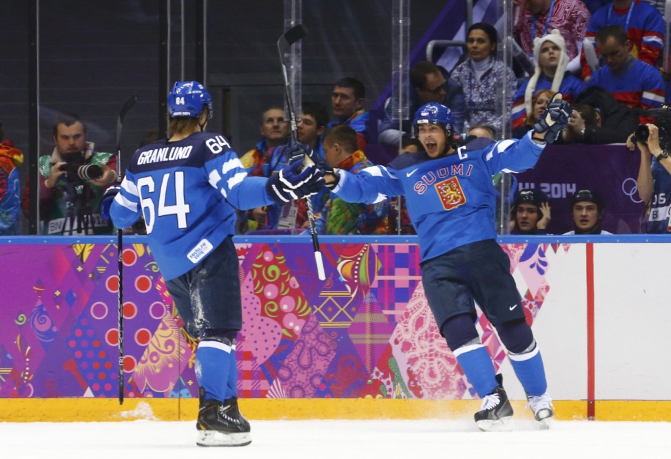 Finland's Selanne celebrates his goal against Russia with teammate Granlund during the first period of their men's quarter-finals ice hockey game at the 2014 Sochi Winter Olympic Games