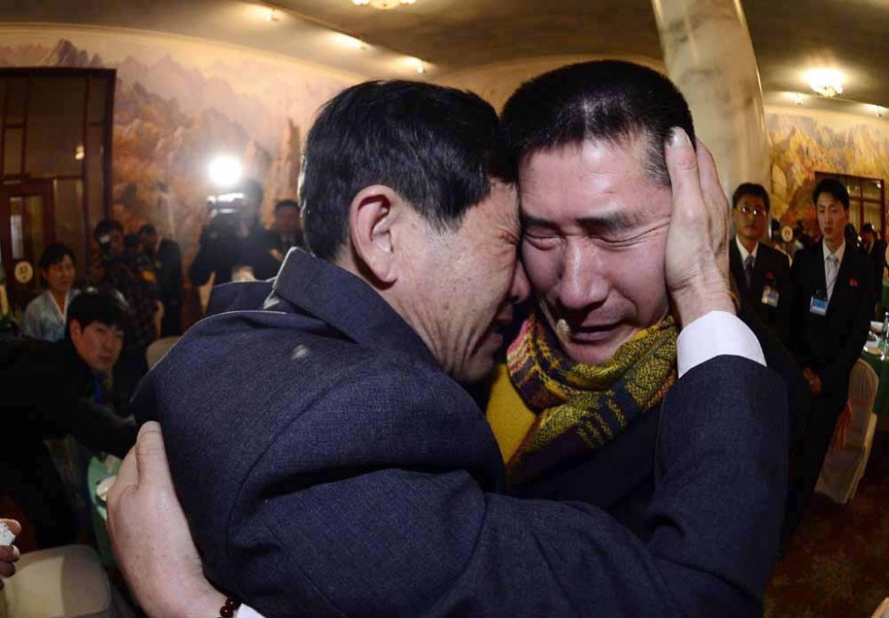 South Korean Park Yang-gon, 53, and his North Korean brother Park Yang-su, who was abducted by North Korea, cry during their family reunion in North Korea