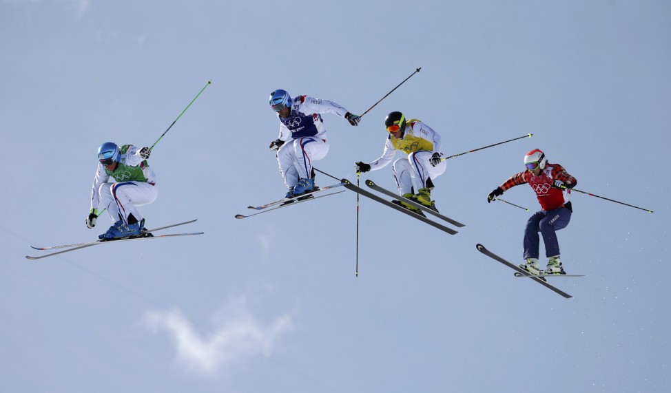 France's Chapuis competes with compatriots Bovolenta and Midol and Canada's Leman during men's freestyle skiing skicross finals round at 2014 Sochi Winter Olympic Games in Rosa Khutor