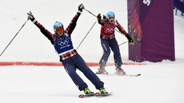 Winner Marielle Thompson and second-placed Kelsey Serwa, both of Canada, react during the women's freestyle skiing skicross finals at the 2014 Sochi Winter Olympic Games in Rosa Khutor
