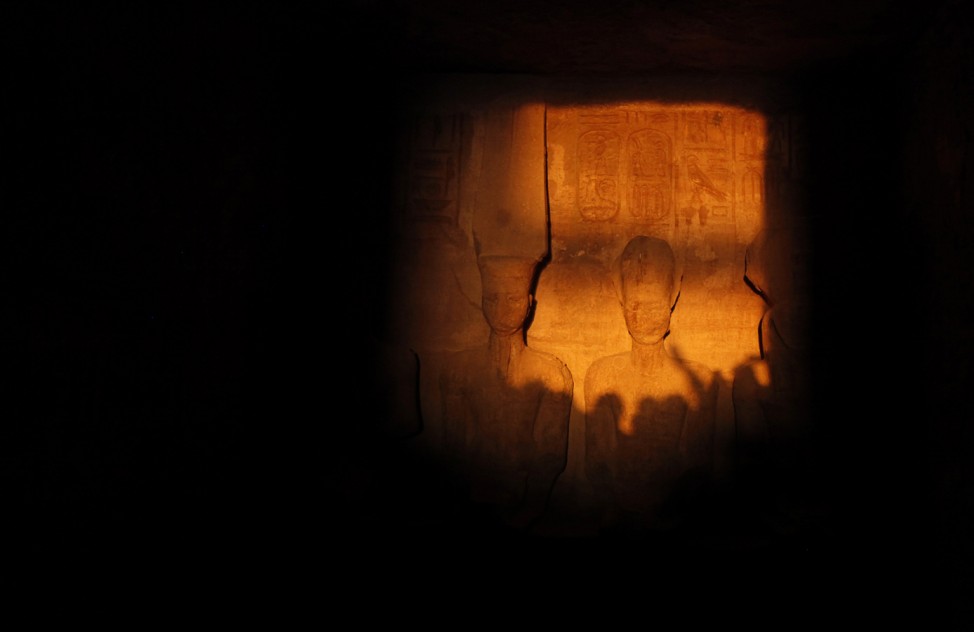 The light of dawn shines on the statues of Pharaoh Ramses II and Amun, the God of Light, in the inner sanctum of the temple of Abu Simbel, located at the upper reaches of the Nile in Aswan