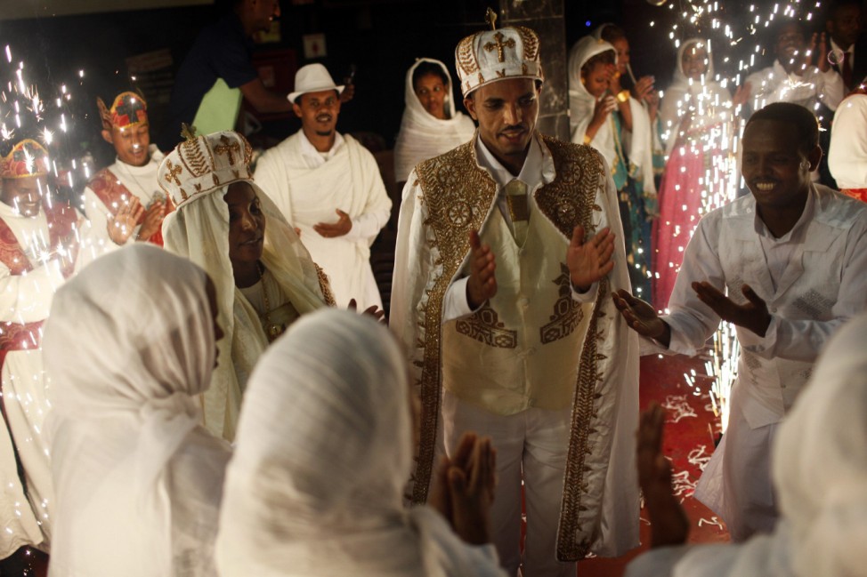 Bride Azeb Ghebremichael and groom Testfom Girmay wear traditional dress during an Eritrean Orthodox Christian wedding ceremony in Tel Aviv