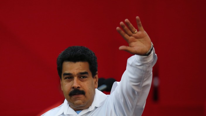 Venezuela's President Nicolas Maduro greets suporters as he arrives at a rally with workers in Caracas