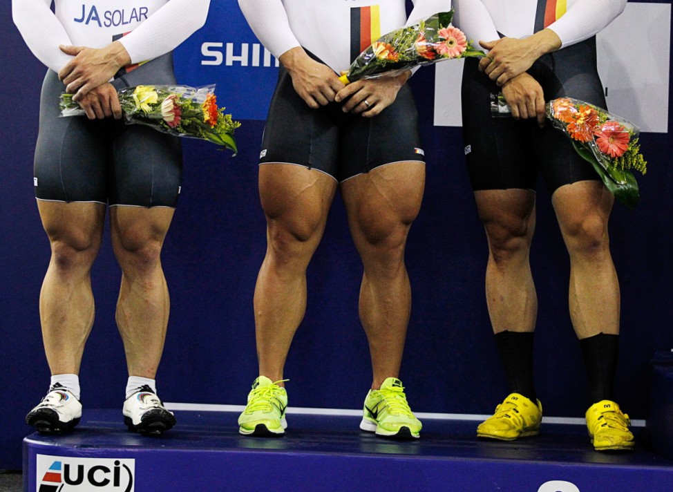 The legs of second placed German team, including Rene Enders, Robert Forstemann and Maximilian Levy are pictured during the ceremony in the men's team sprint race at the 2014 UCI Track Cycling World Championships in Cali