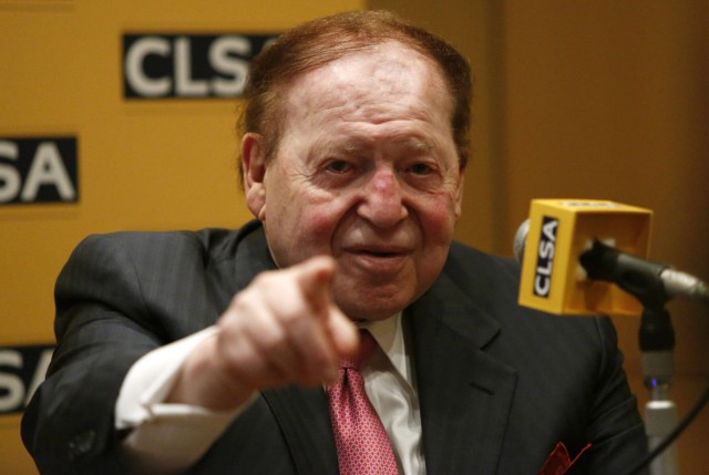 Las Vegas Sands Corp Chairman and CEO Sheldon Adelson points a reporter during a news conference in Tokyo