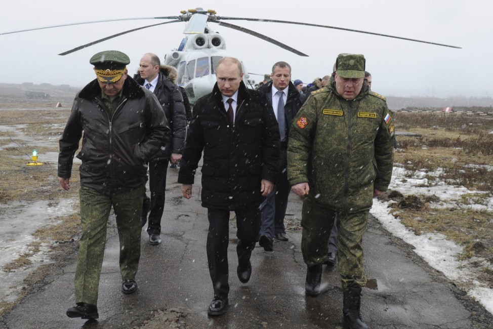 Russia's President Putin, accompanied by Russian Defence Minister Shoigu, walks to watch military exercises upon his arrival at Kirillovsky firing ground in Leningrad region