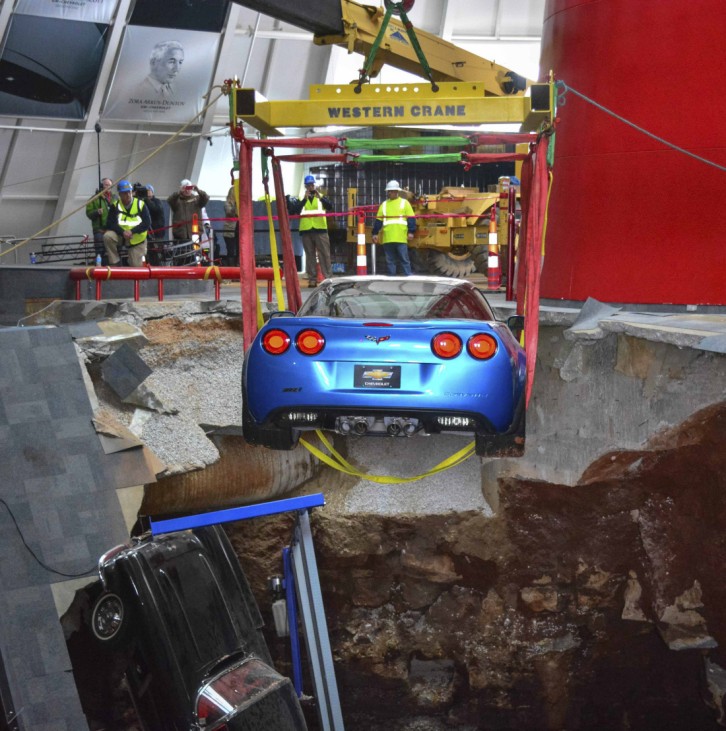 Workers use a crane to recover the 2009 Corvette ZR-1 'Blue Devil,' from the sinkhole at the National Corvette Museum in Kentucky