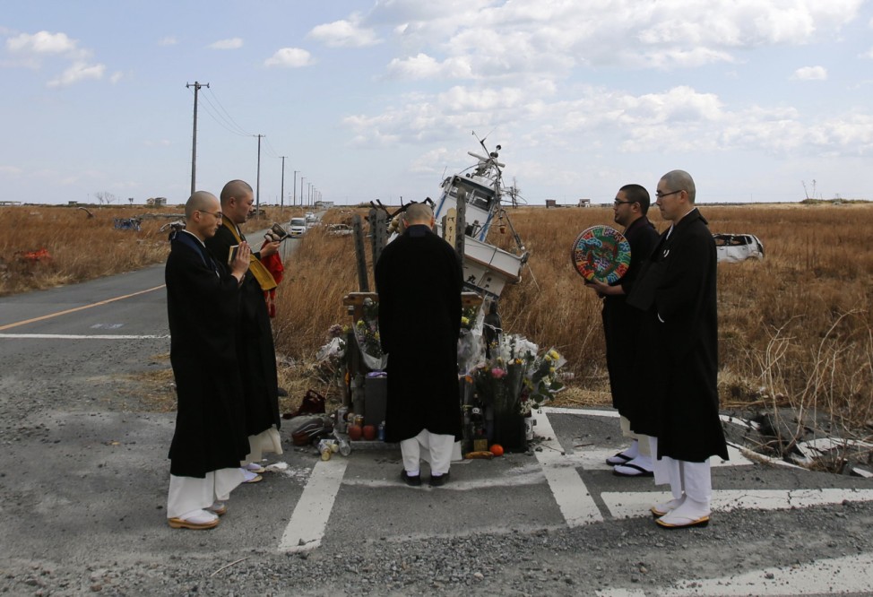 Buddhist monks offer prayers for victims of the March 11, 2011 earthquake and tsunami in Namie