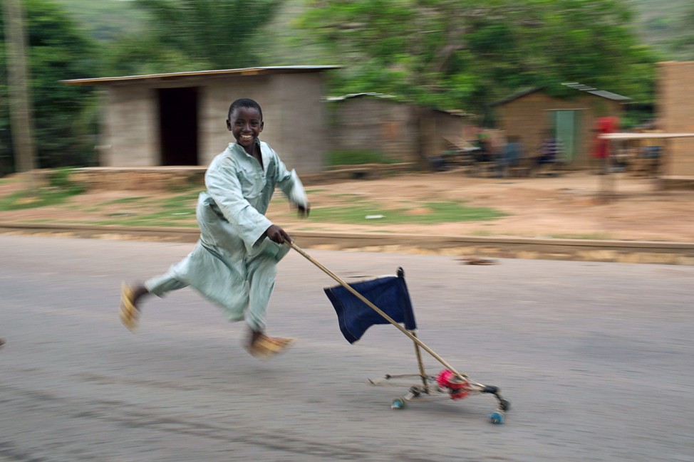A boy runs past with a home made toy car in an area where several Muslims are still stranded due to the ongoing sectarian violence near Kilometre 12 (PK12) in the capital Bangui