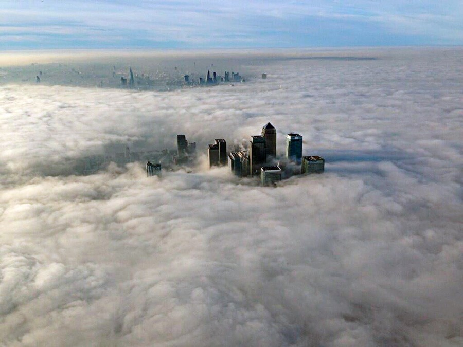 The Canary Wharf financial district and central London emerge from morning fog in this aerial photograph released by the Metropolitan Police in London
