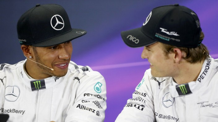Mercedes Formula One driver Hamilton of Britain talks with teammate, Mercedes Formula One driver Rosberg of Germany during a news conference after the qualifying session for the Australian F1 Grand Prix in Melbourne