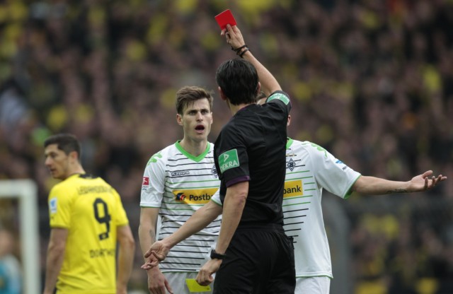 Referee Aytekin shows a red card to Borussia Moenchengladbach's Nordtveit during the German first division Bundesliga soccer match against  Borussia Dortmund in Dortmund