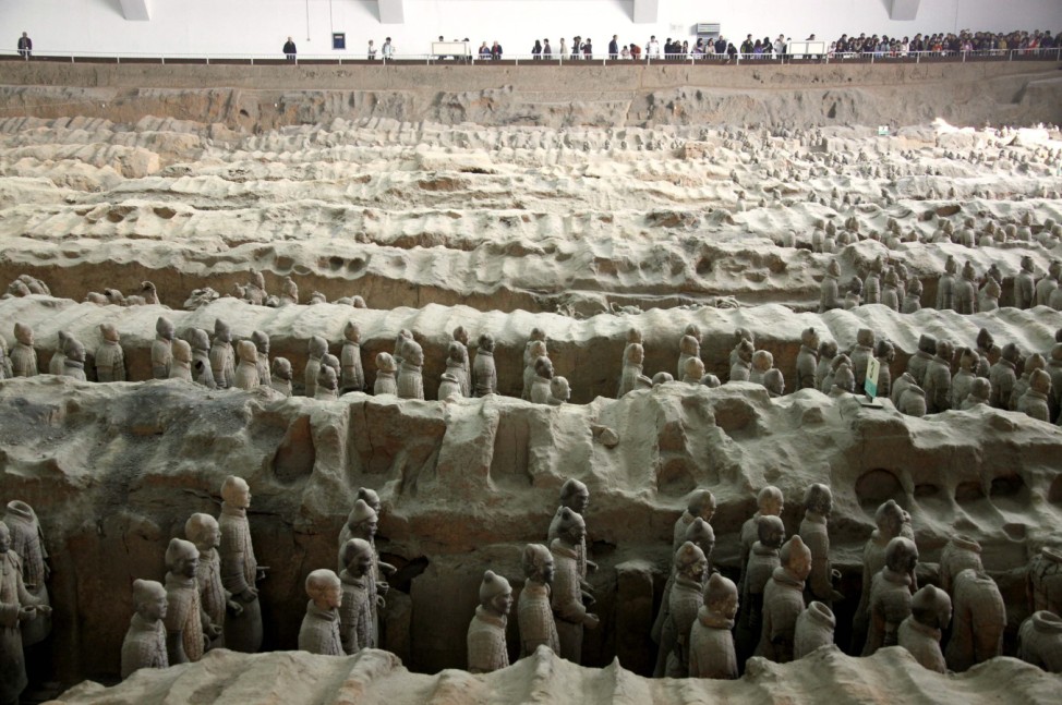 Tourists file past terracotta warriors at the excavation site located on the outskirts of the Chinese city of Xian