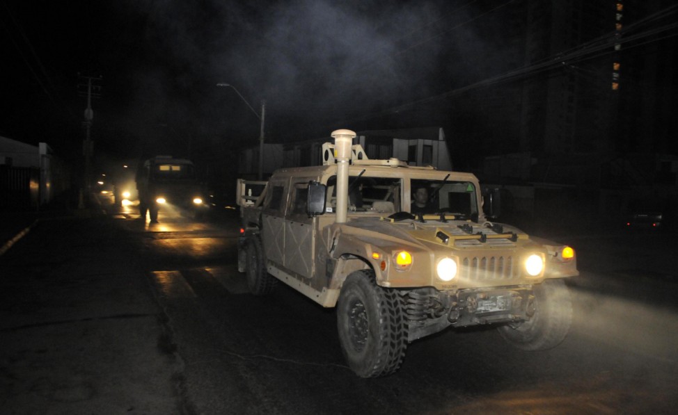 A military convoy travels along a road after a tsunami alarm at Iquique city