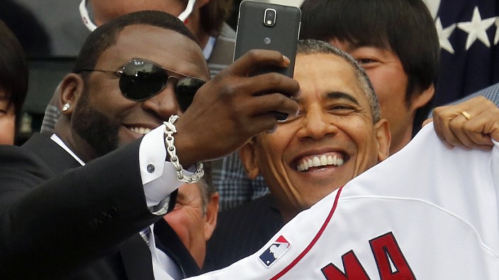 U.S. President Barack Obama poses with player David Ortiz for a 'selfie' as he welcomes the 2013 World Series Champion Boston Red Sox to the South Lawn of the White House in Washington