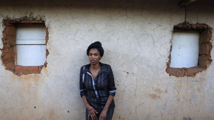 Ernestine poses for photographs outside her home on the 20th anniversary of the genocide in Kigali