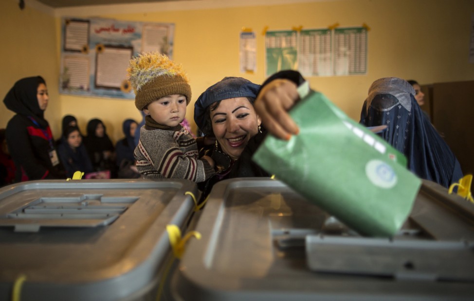 An Afghan woman casts her ballot at a polling station in Mazar-i- sharif