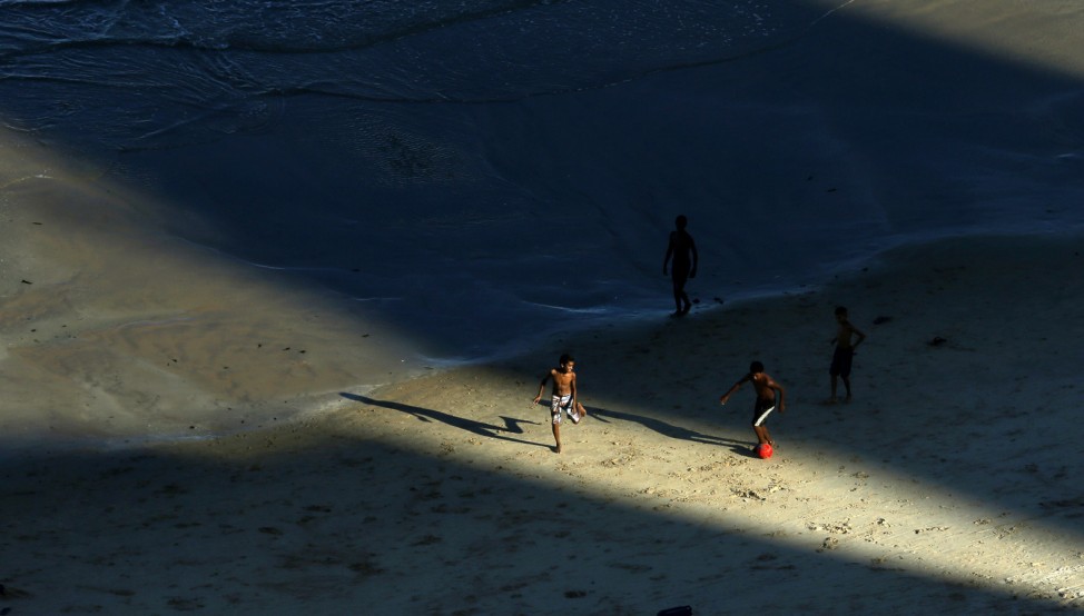 Children play with a ball on the Boa Viagem beach in the northeastern Brazilian state of Recife