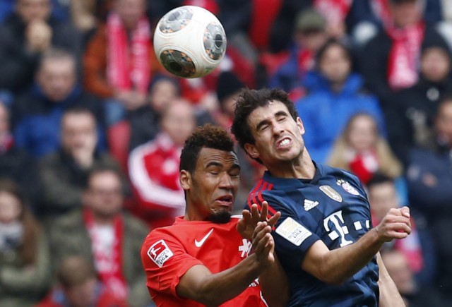 FSV Mainz 05's Choupo-Moting (L) and  Bayern Munich's Martinez head for the ball during their German first division Bundesliga soccer match in Mainz