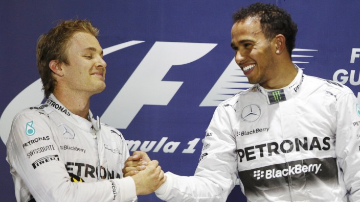 Hamilton of Britain is congratulated by Rosberg of Germany on the podium after he won the Bahrain F1 Grand Prix at the Bahrain International Circuit (BIC) in Sakhir