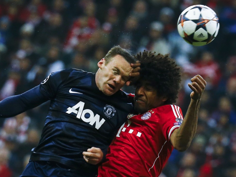 Manchester United's Rooney goes for a header with Bayern Munich's Dante during their Champions League quarter-final second leg soccer match in Munich