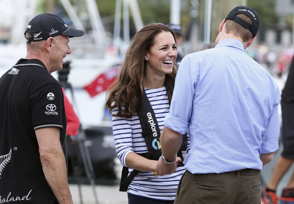 A crew member watches as William laughs with his wife Catherine after they sailed aboard two America's Cup yachts on Auckland Harbour