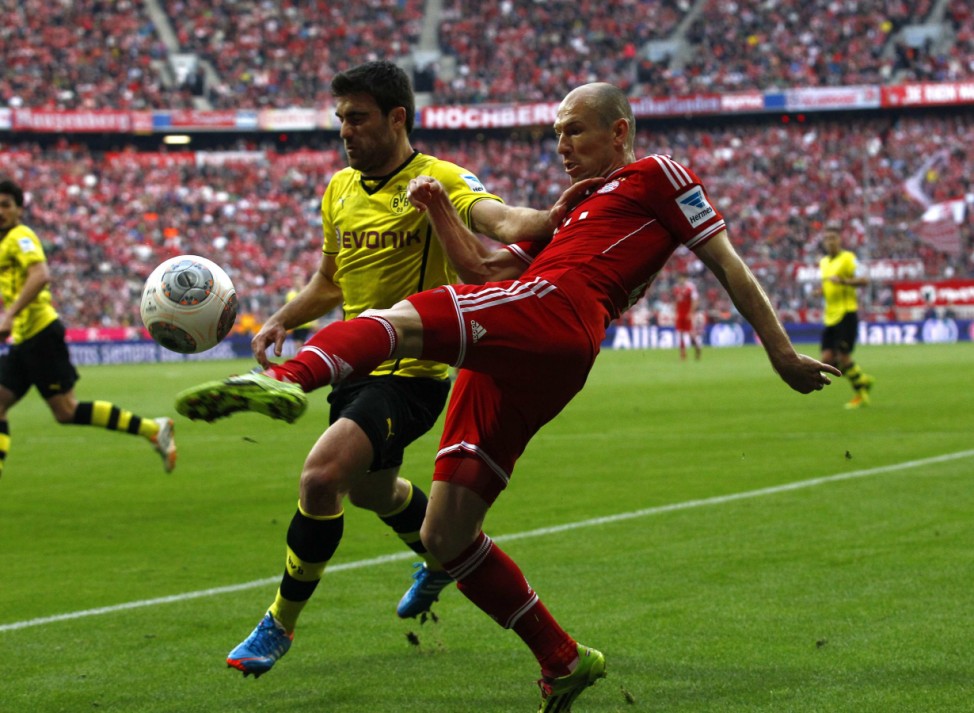 Bayern Munich's Robben is tackled by Borussia Dortmund's Sokratis during German Bundesliga first division soccer match in Munich