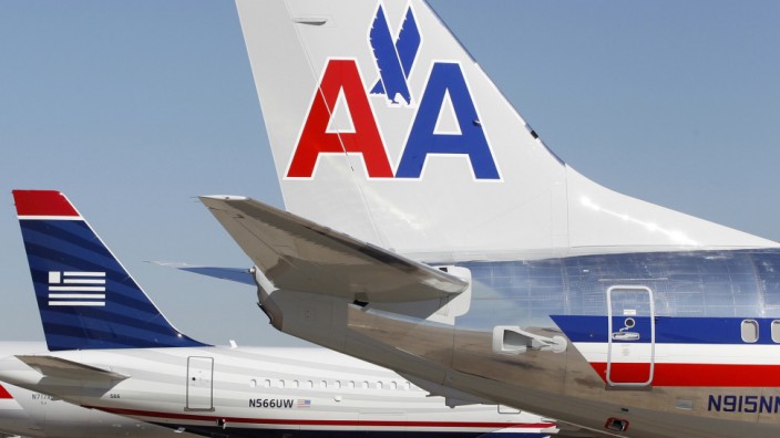 The tail sections of a newly designed American Airlines aircraft,  a US Airways aircraft and a traditional American Airlines aircraft are lined up at at Dallas-Ft Worth International Airport in this file photo