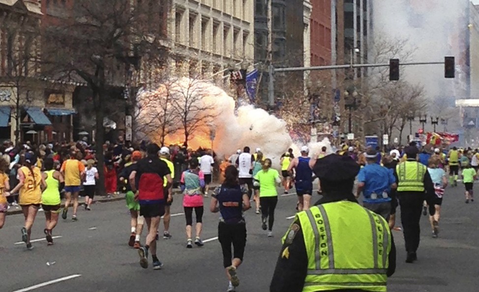 File photo of runners running towards the finish line as an explosion erupts at the finish line of the Boston Marathon