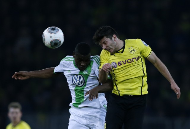 VfL Wolfsburg's Malanda-Adje and Borussia Dortmund's Milos Jojic fight for the ball during German soccer cup semi-final match in Dortmund