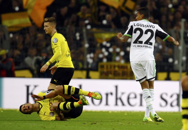 VfL Wolfsburg's Gustavo Dias challenges Borussia Dortmund's Kehl during German soccer cup semi-final match in Dortmund