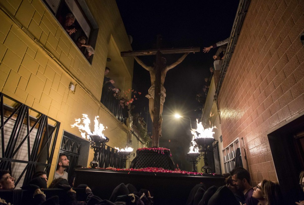 People gather to see image of the El Perdon Christ during a Holy Week procession in Almeria